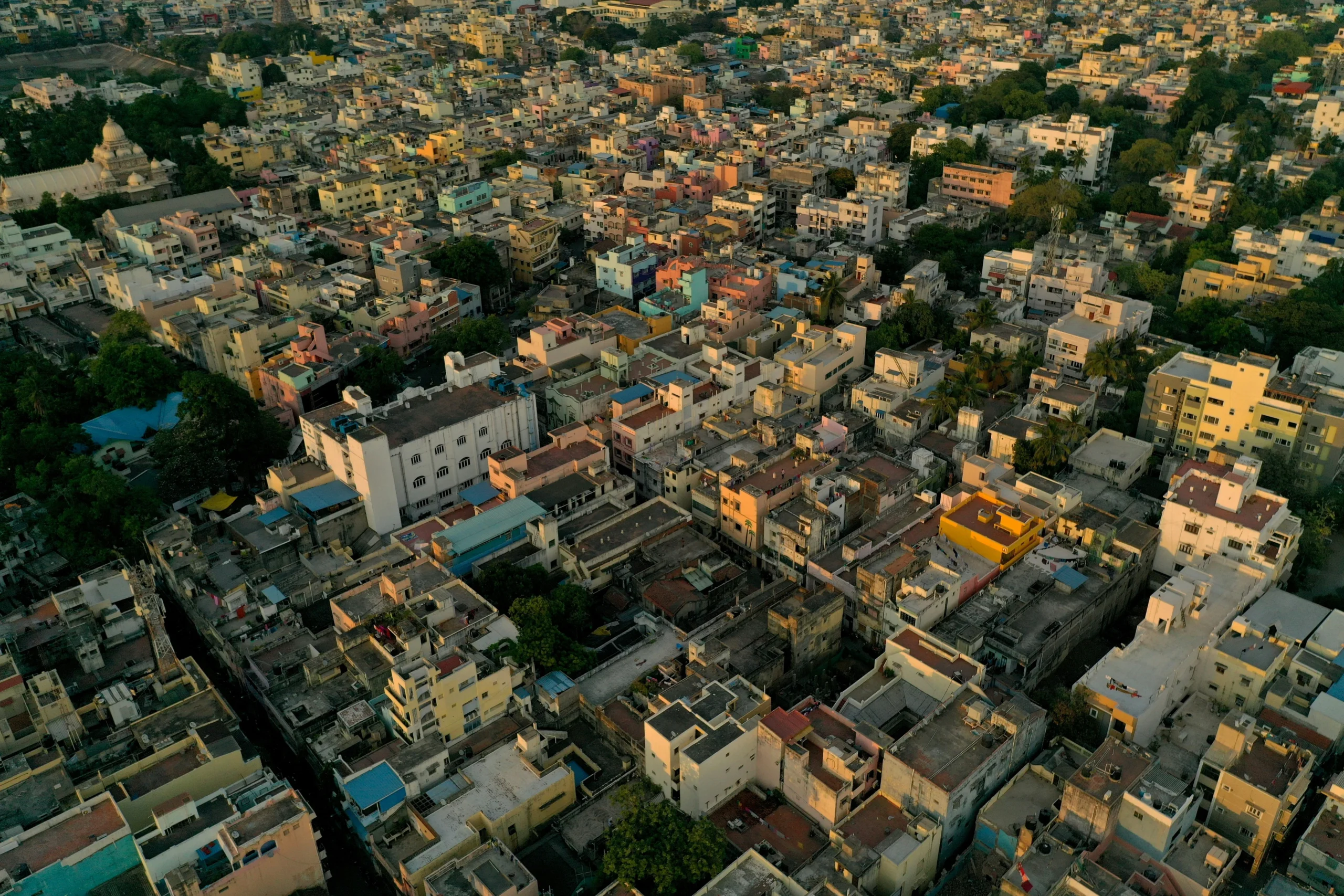 Aerial view of a densely populated residential neighborhood in India Aerial view of a densely populated urban residential area in India with colorful buildings, streets, trees, and homes